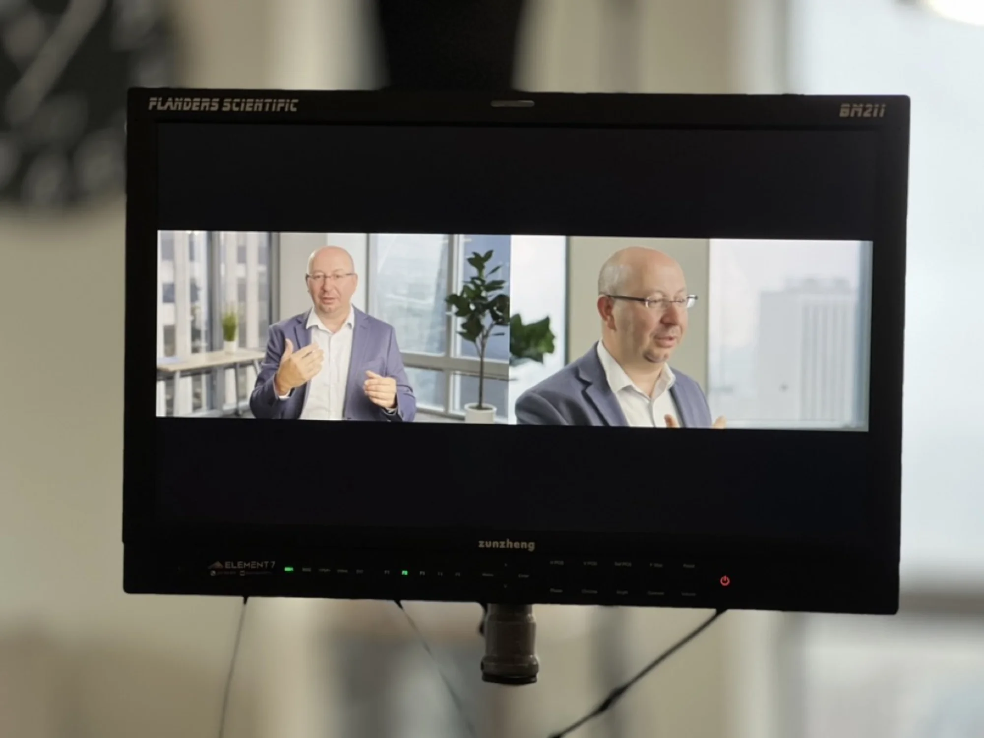 Flanders Scientific BM211 monitor showing dual-camera interview feeds with Element 7 branding
