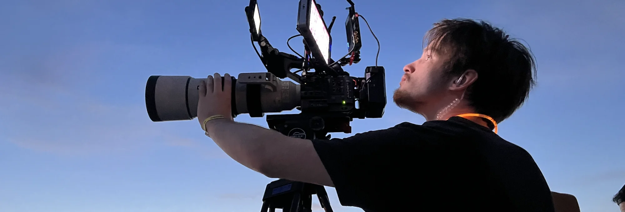 Video production crew setting up camera equipment in event venue