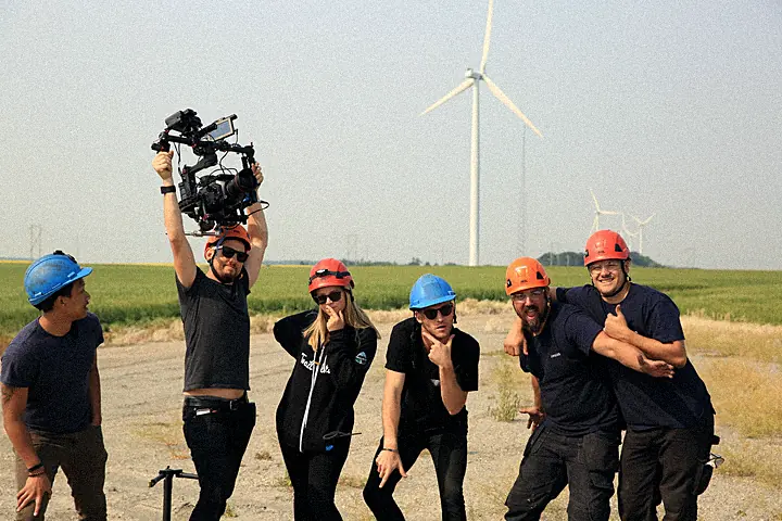 The Element 7 crew in hard hats at the base of the wind farm