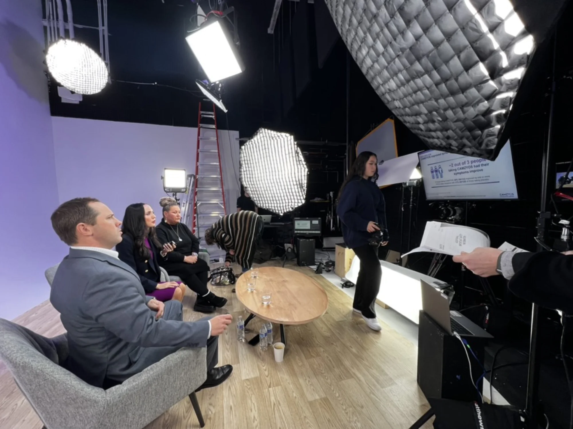 Interview set with seated guests and production lighting