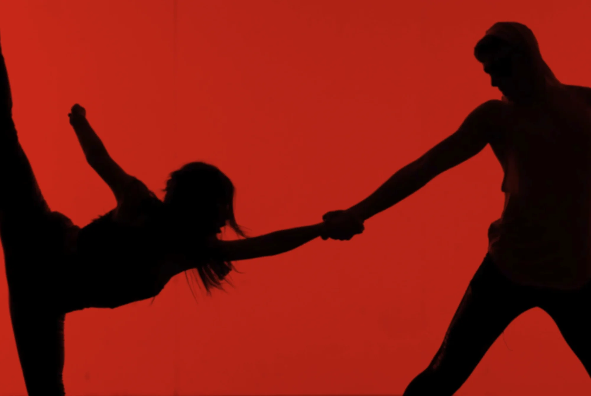 Dancing performance silhouette on red cyc wall